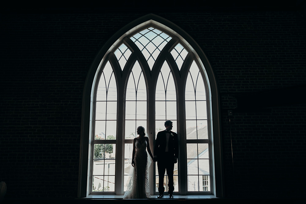 Ashley and Peter pose in the arched window's of Felicity Church's choir loft.