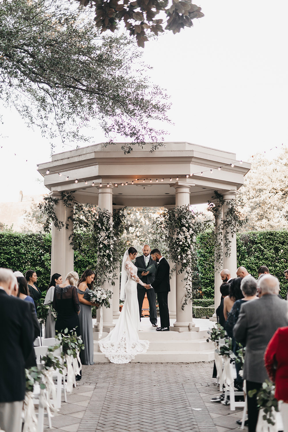 Kimberly and Carlo say their wedding vows in the gazebo at The Elms Mansion
