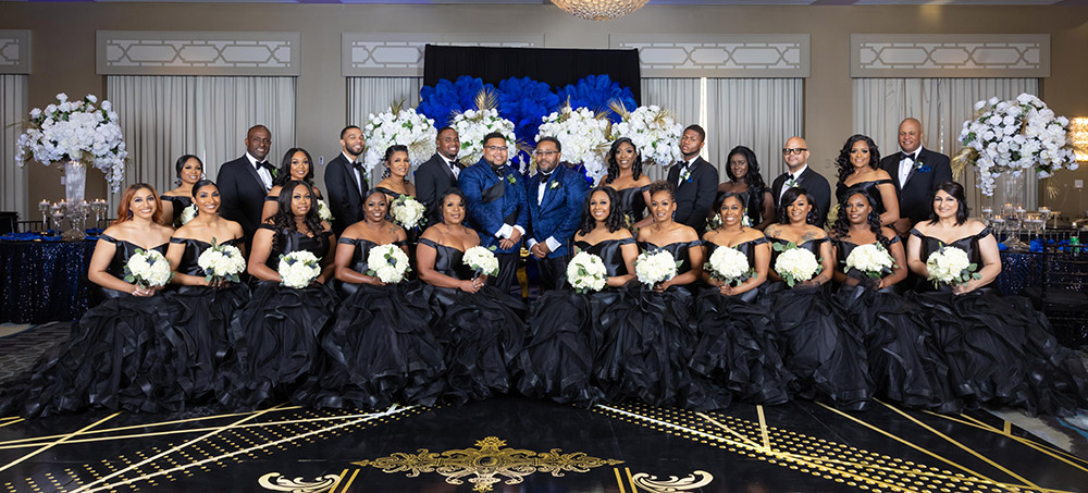 the wedding party in black and grooms in blue
