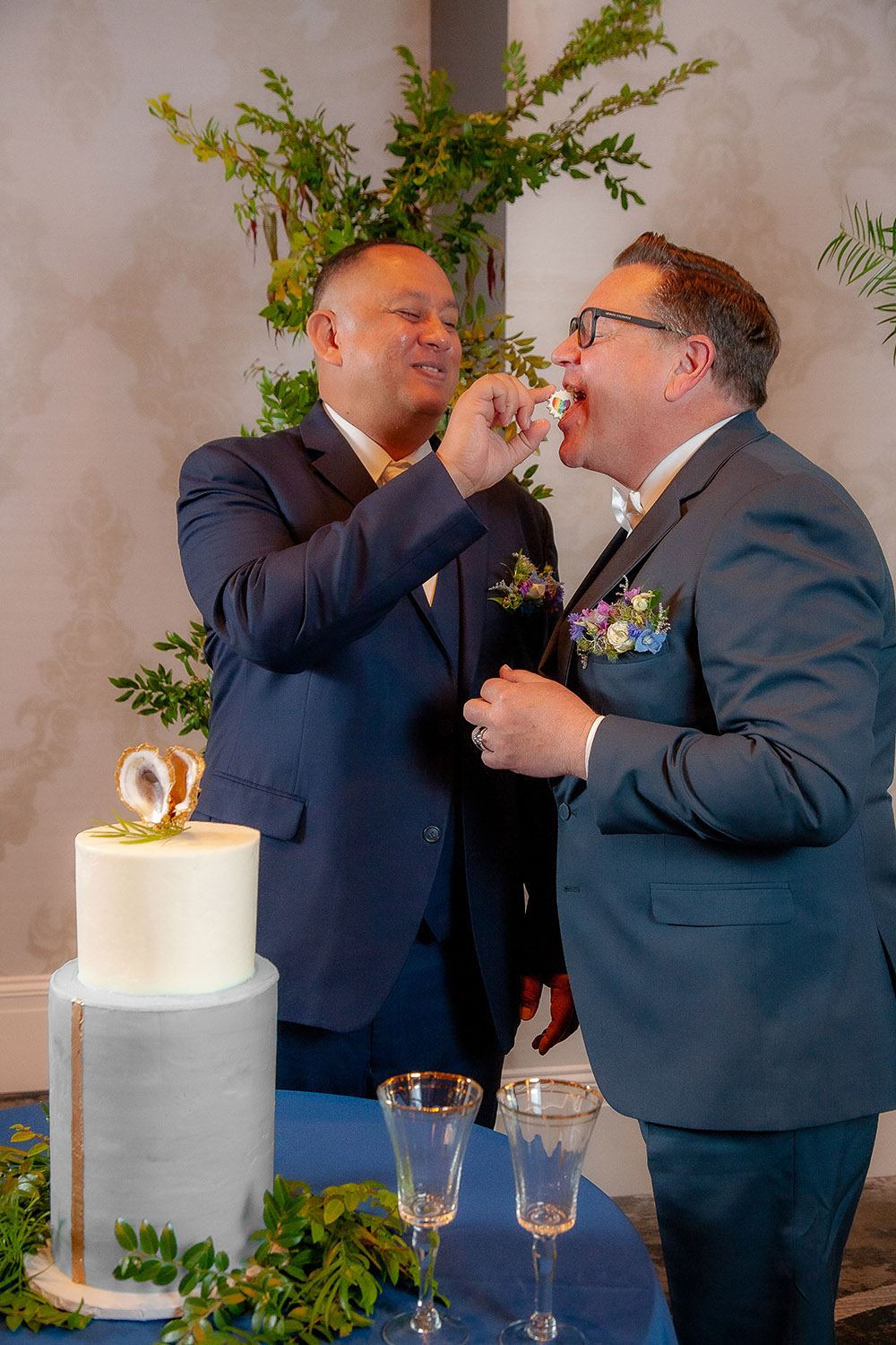 the grooms feed each other pride meringues