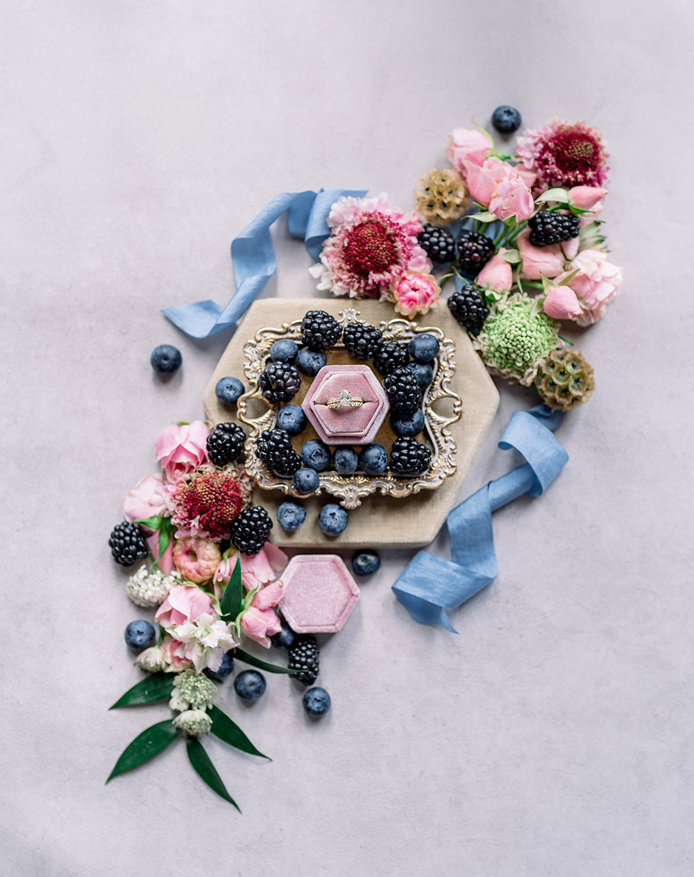 diamond engagement ring surrounded by fruit and flowers