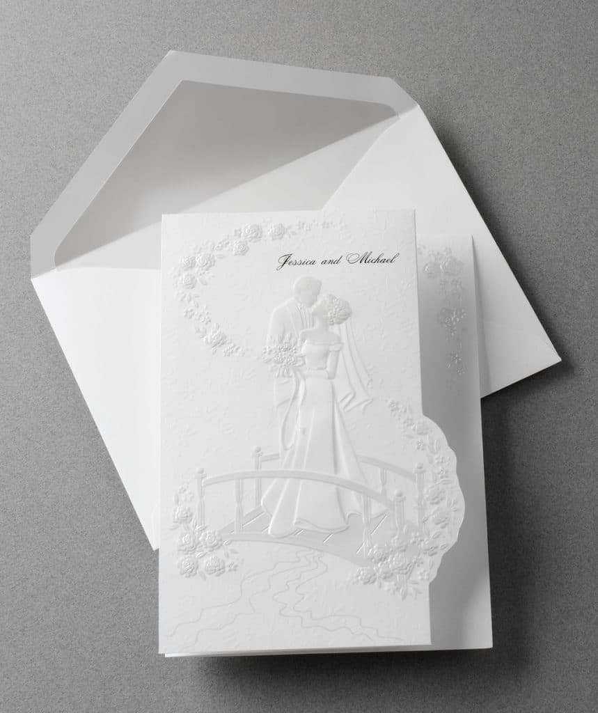 All white embossed wedding invitation by Abbey Printing.
