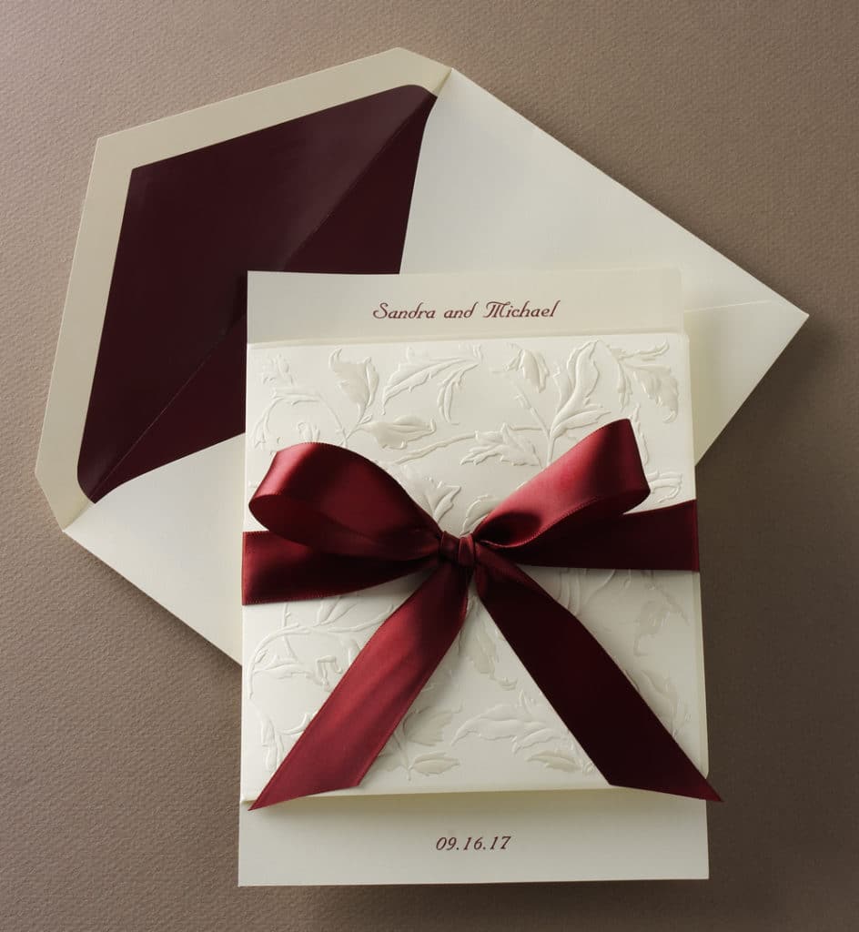 Wedding invitation with burgundy satin ribbon by Abbey Printing.
