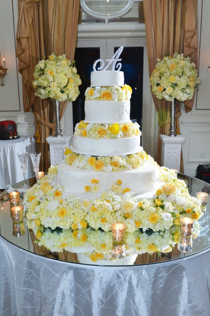 White wedding cake with yellow flowers by Haydel's Bakery