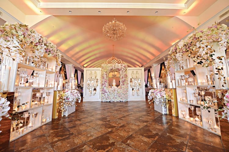 Elegant New Orleans wedding venue with floral arrangements, candles, gold accents, and a chandelier for romantic inspiration.