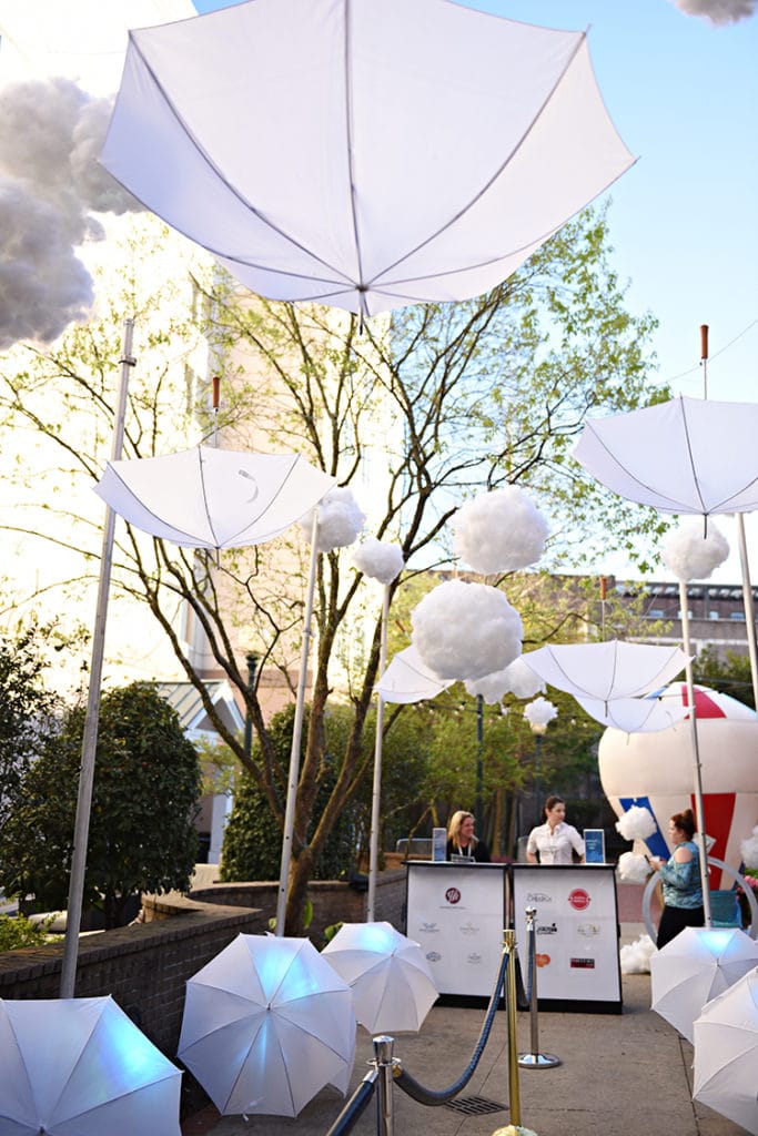 Umbrellas and cloud lanterns, as envisioned by Belladeux Event Design, "float" over the courtyard entrance to <a href=