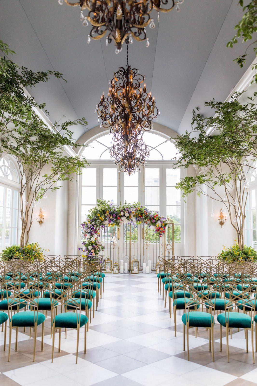 Wedding Ceremony set at Marche with True Value Rental Chameleon Chairs with green cushions. Photo by: Aislinn Kate Photography