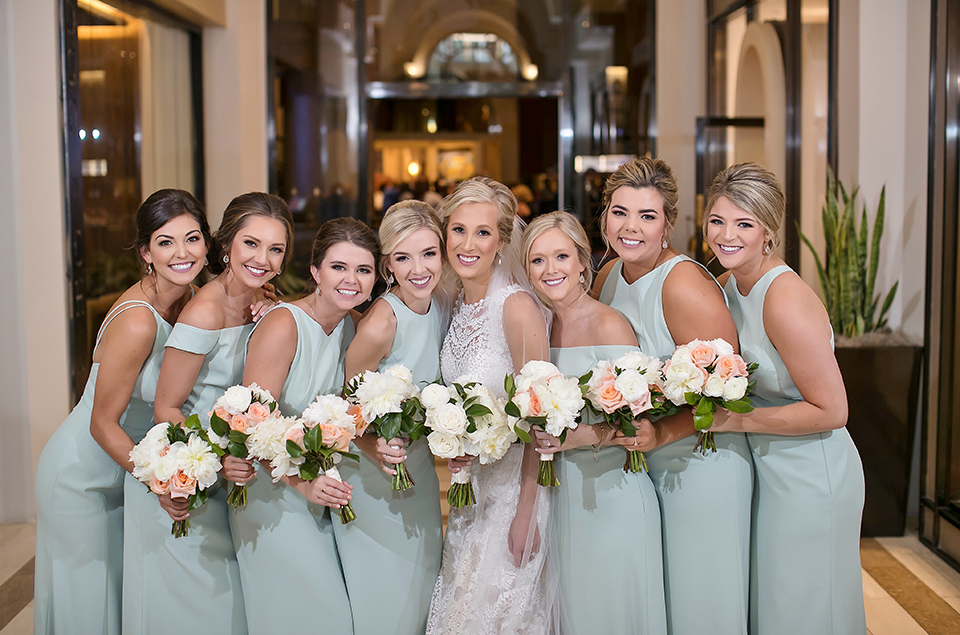 A bride and her bridesmaid pose for a photo before the wedding. Photo: Secondline Photography