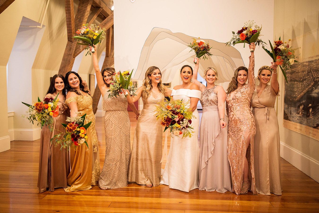 Susan's bridesmaids each wore a different style dress within a warm golden and blush color palette.