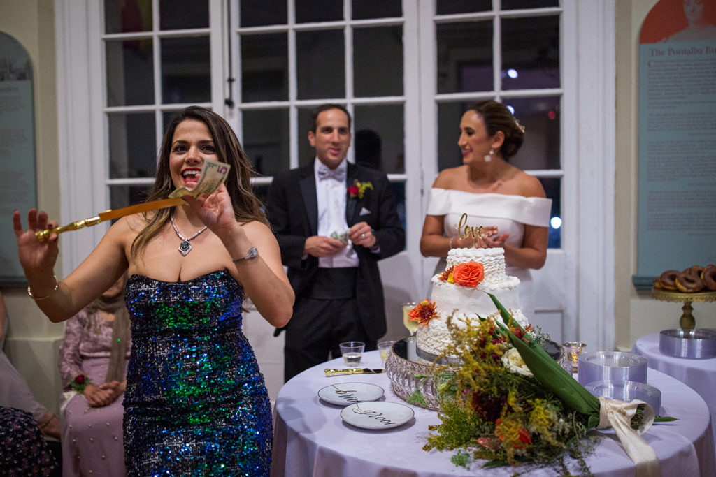 The wedding festivities included a traditional Persian knife dance called the “Raghseh Chagoo” where guests “steal” the cake knife and dance with it and the couple must pay to get it back. Several guests danced with the knife before giving it to the happy couple to cut their wedding cake.