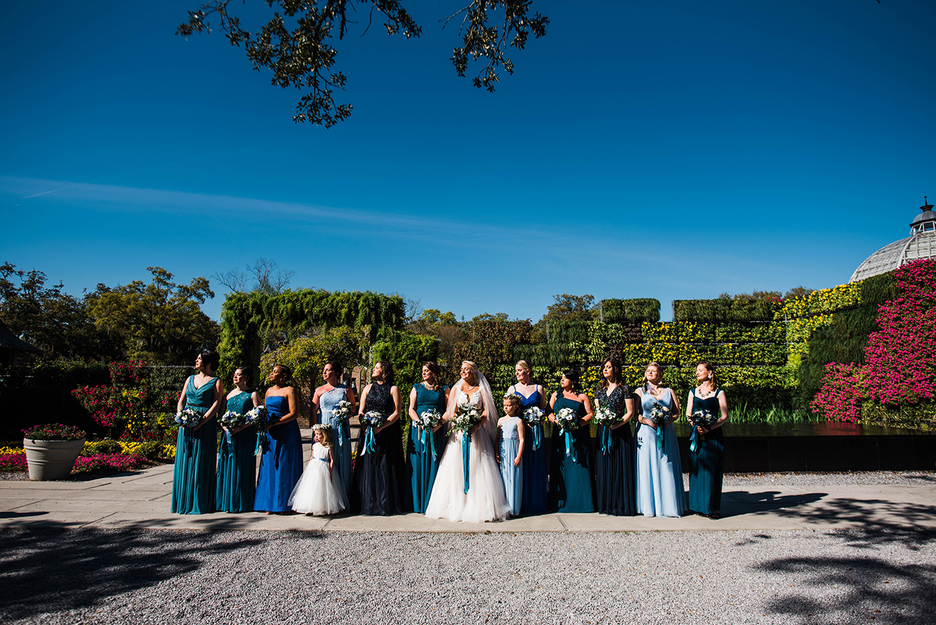 Kate provided her bridesmaids a teal and blue paint chip color palette and allowed them to each select their own gowns. “It blended great!” she shares of the resulting looks.