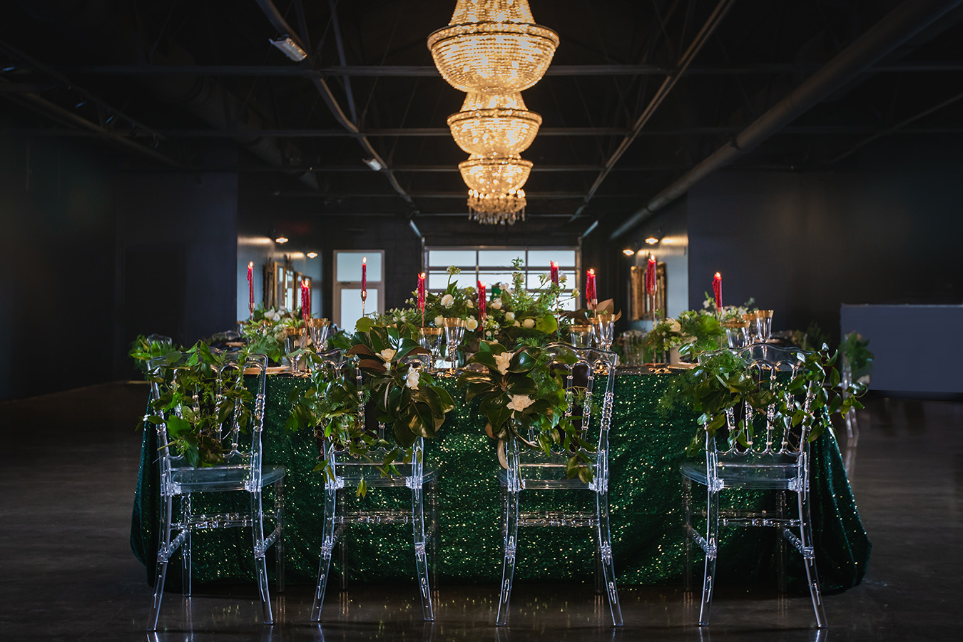 Wedding reception table at The Parlor at The Pontchartrain Hotel featuring green sequin linen and clear Napoleon chairs. Photo by: Brian Jarreau Photography