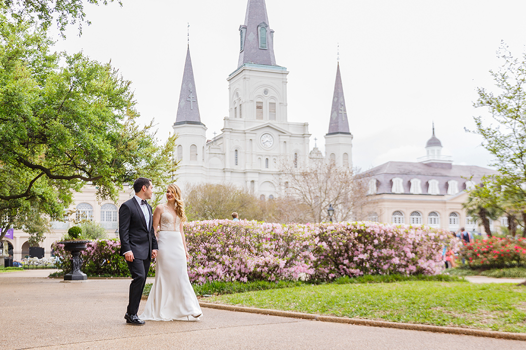 Alex and Greg walk thru Jackson Square in New Orleans' French Quarter on their wedding day. | photo by Studio Tran