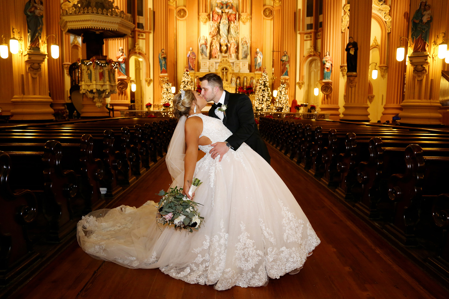 David and Courtney stop for a kiss after their wedding ceremony at St. Mary's Assumption Church in New Orleans.