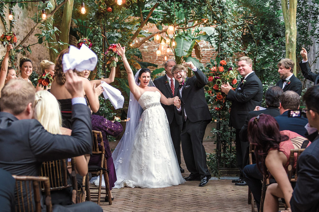 A newly married couple celebrates at The New Orleans Pharmacy Museum. Photo by The Red M Studio