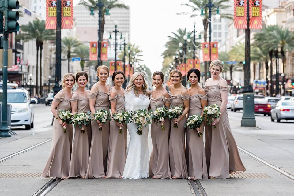 Bride with Bridesmaids on Canal Street in New Orleans. Photo by Studio Orleans Photography