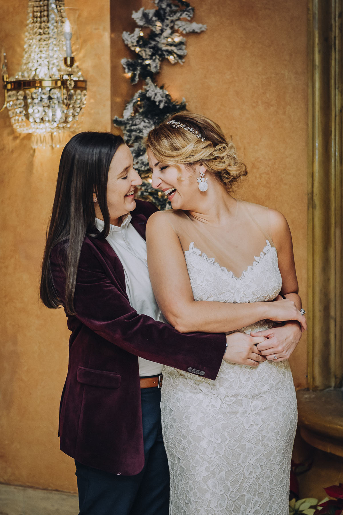 Newly wed brides embrace on their wedding day. Photo: Capture Studio Photography
