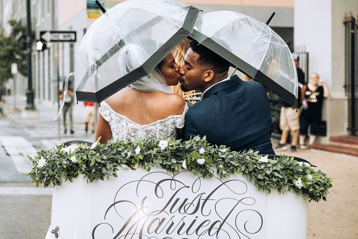 Newlyweds kiss as they leave their wedding in a pedicab in the French Quarter. Photo: Capture Studio Photography