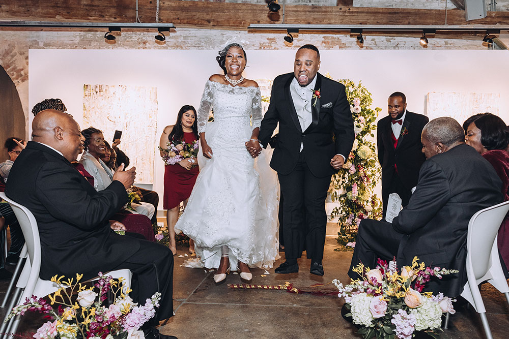 bride and groom jumping the broom