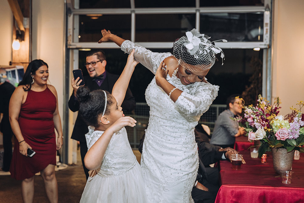 bride and flower girl dancing