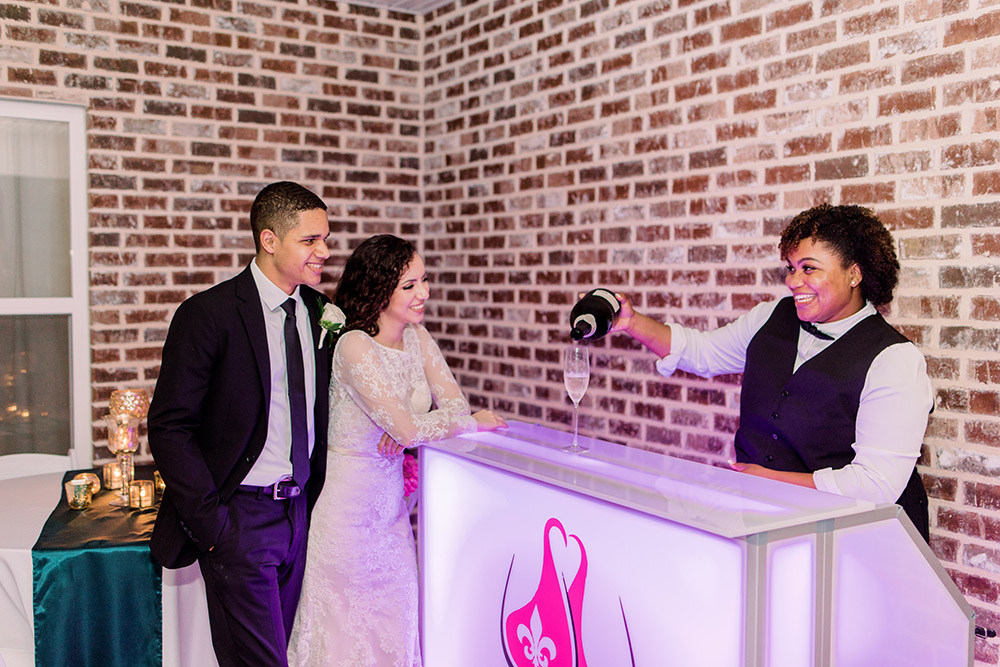 Nola Accent Bartenders serves the bride and groom a glass of champagne. Photo: Ashley Kristen Photography