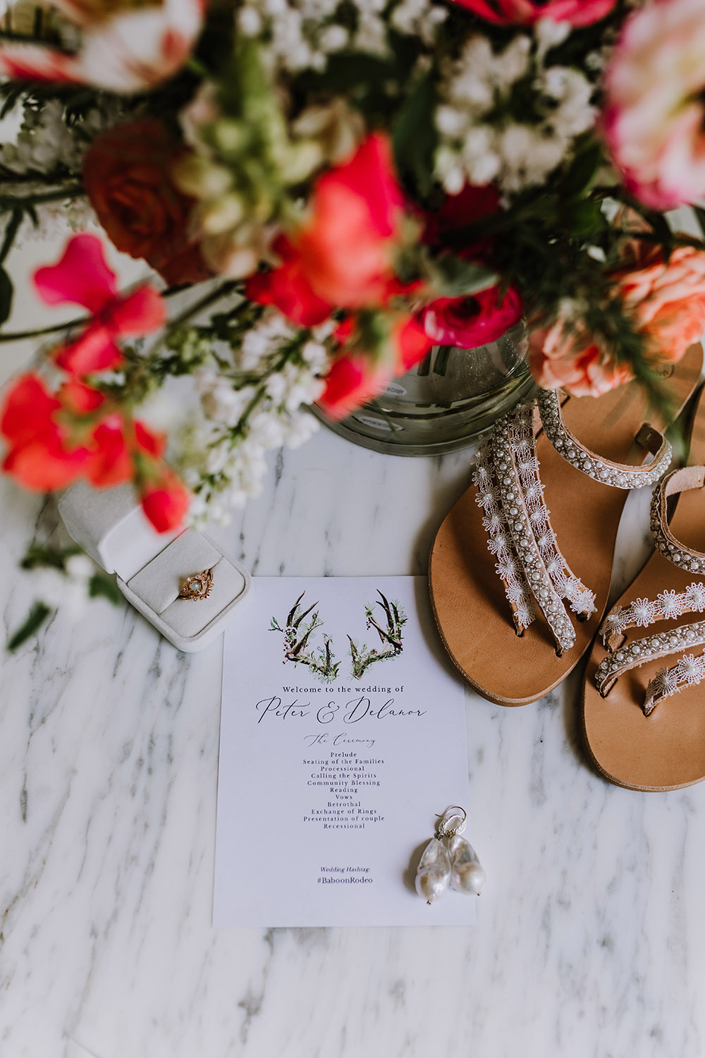 Wedding details including the wedding program, bridal bouquet, engagement ring, earrings and wedding shoes. Photo: Ashley Biltz