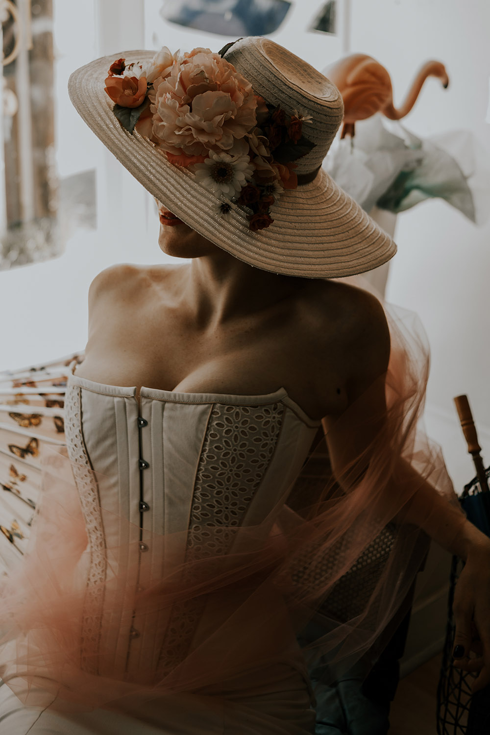 The bride wears a hat with flowers.