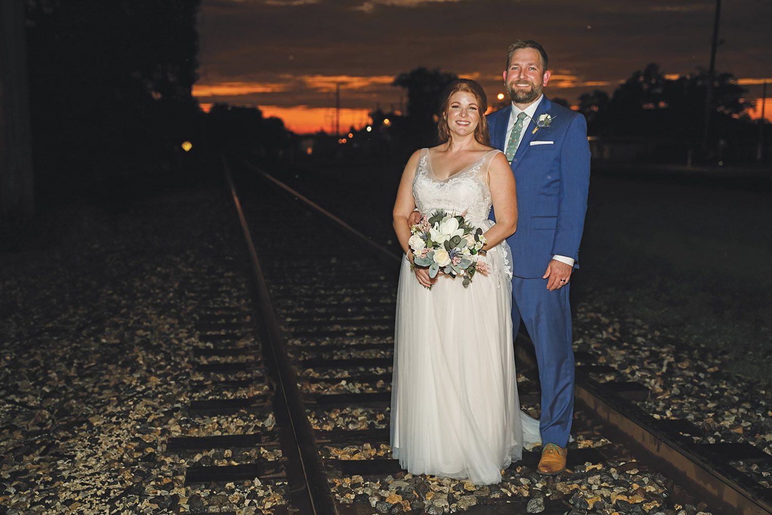Allison and Todd pose on the train tracks near The Crossing