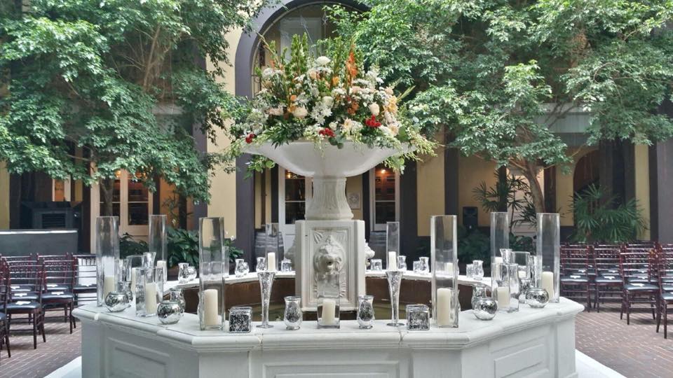 Hotel Mazarin Courtyard Fountain with Floral and Candle Decor