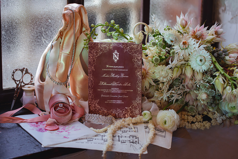 Wedding details including invitation, jewelry and the bouquet.