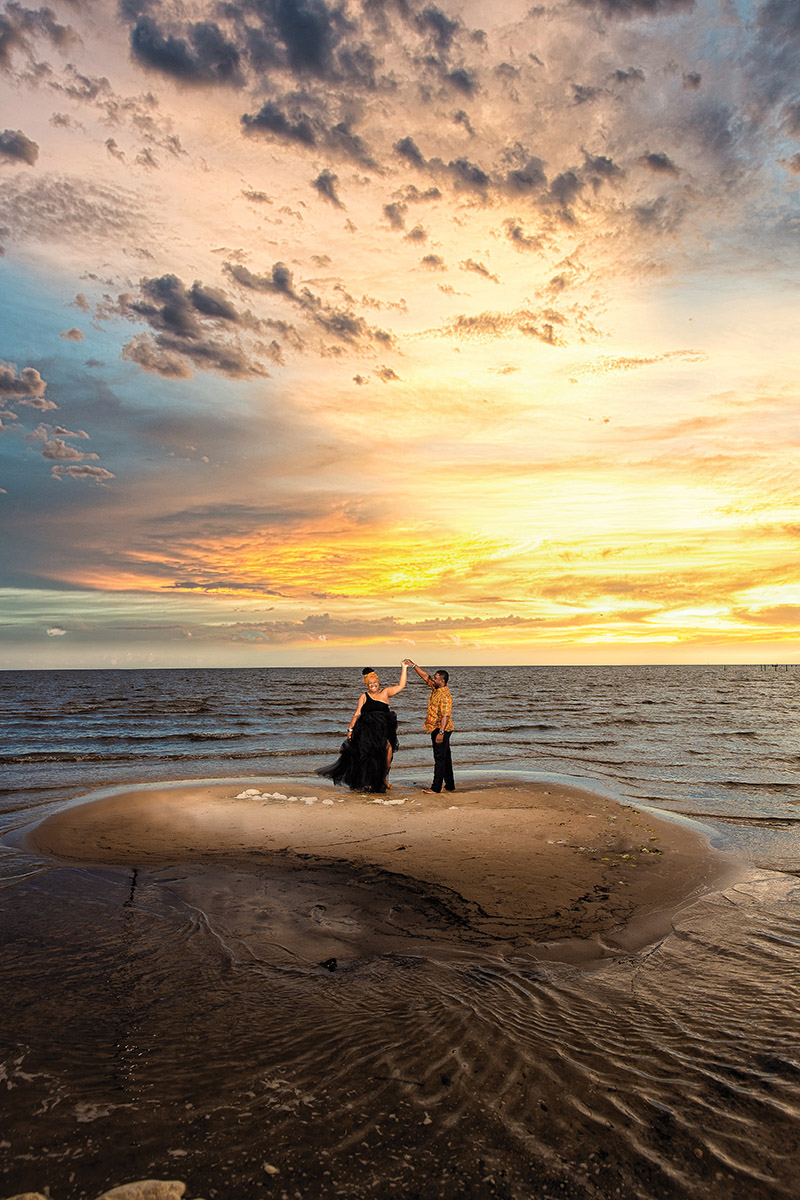 Beach engagement photo at sunset by Amin Russell Photography