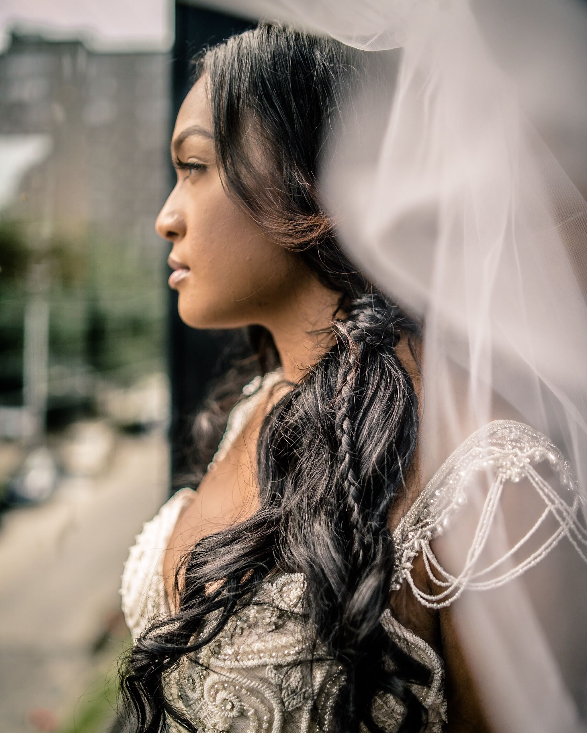 Bride looking out a window XXI Facets Photography