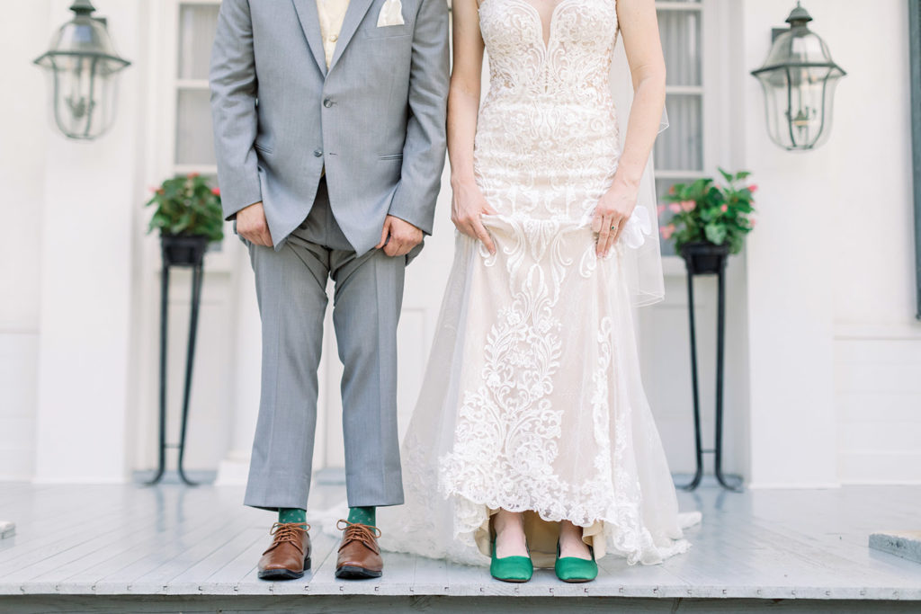 bride and groom show off green wedding socks and shoes photo by Sarah Alleman Photography