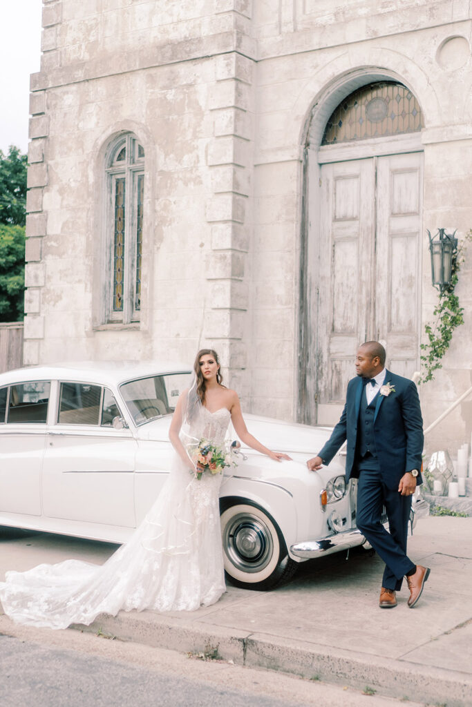 Bride and groom with antique Rolls Royce