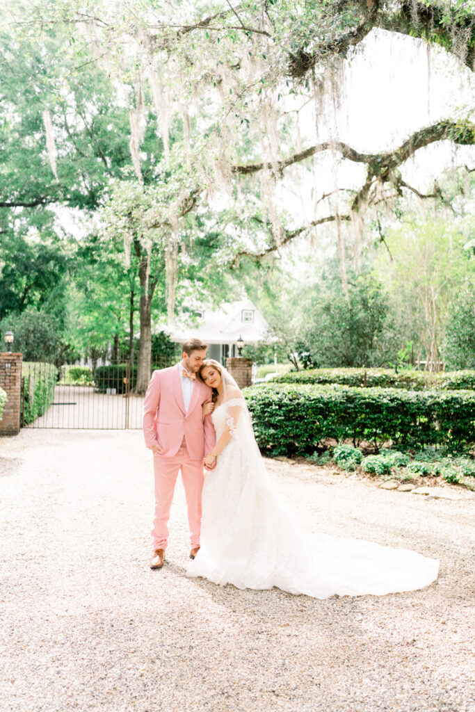 A bride and groom outside the gates of The Henry Smith House in Picayune, Mississippi