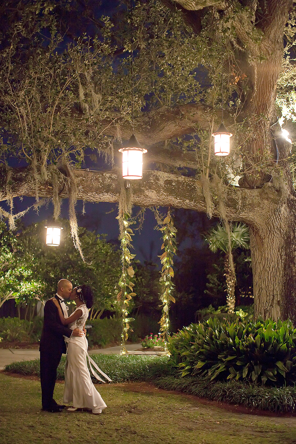 Bride and Groom Kiss under an oak tree