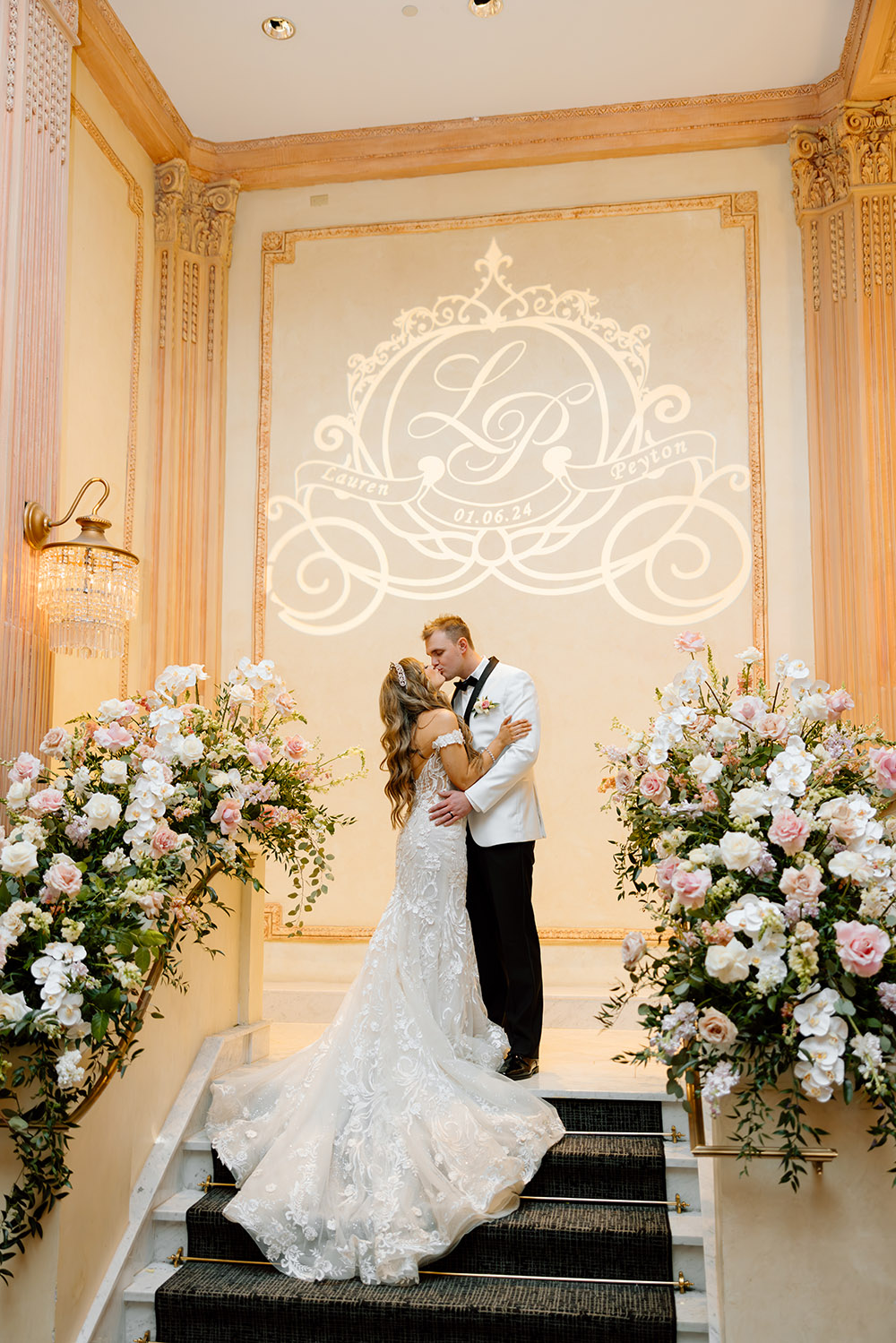 Lauren Wright + Peyton Meadows kiss at their wedding reception in the Crystal Ballroom of the Battle House Hotel in Mobile, AL