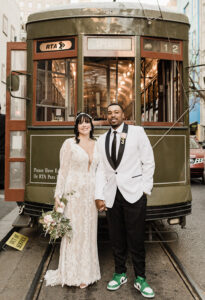 Sarah Austin and Chris Caldwell pose with the St. Charles Streetcar for the New Orleans Wedding