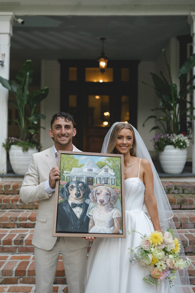 Wedding party portrait on historic home steps with bridesmaids in blush dresses and groomsmen in beige suits.