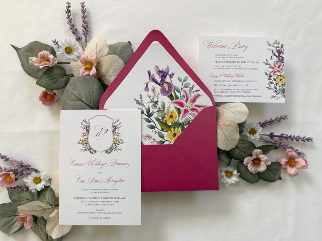 Garden-inspired wedding invitation suite with vibrant floral envelope liner, pink envelopes, lavender accents, and whimsical botanical illustrations.