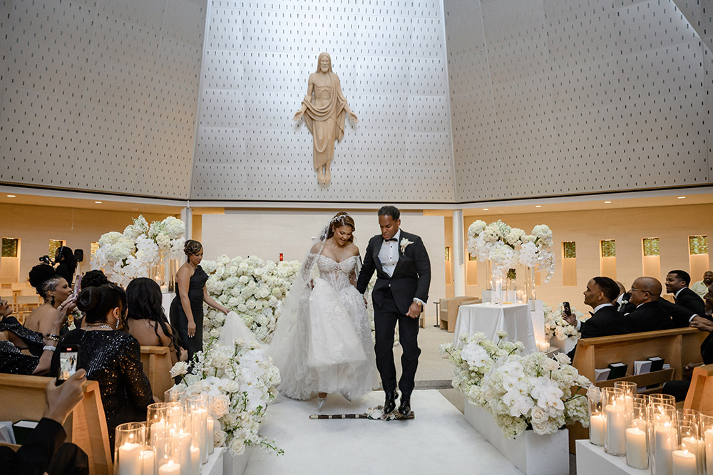 Bride and groom jump the broom