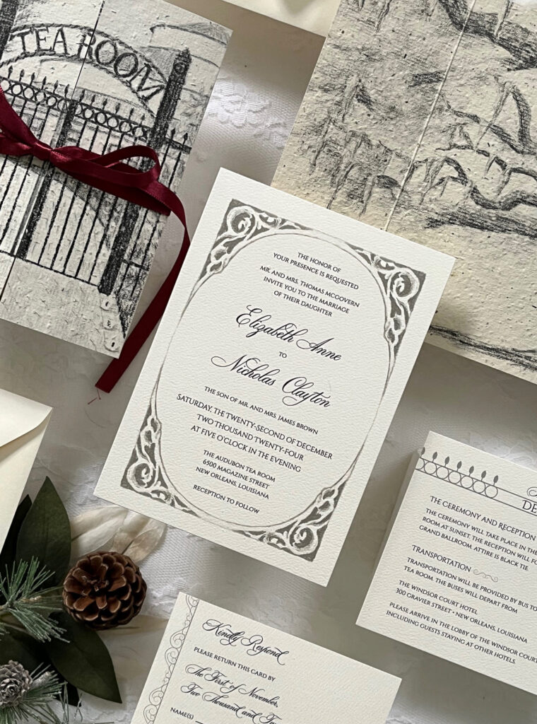 Close-up of vintage-inspired wedding invitation featuring ornate gray border artwork, elegant script typography, and hand-drawn New Orleans sketch illustrations.