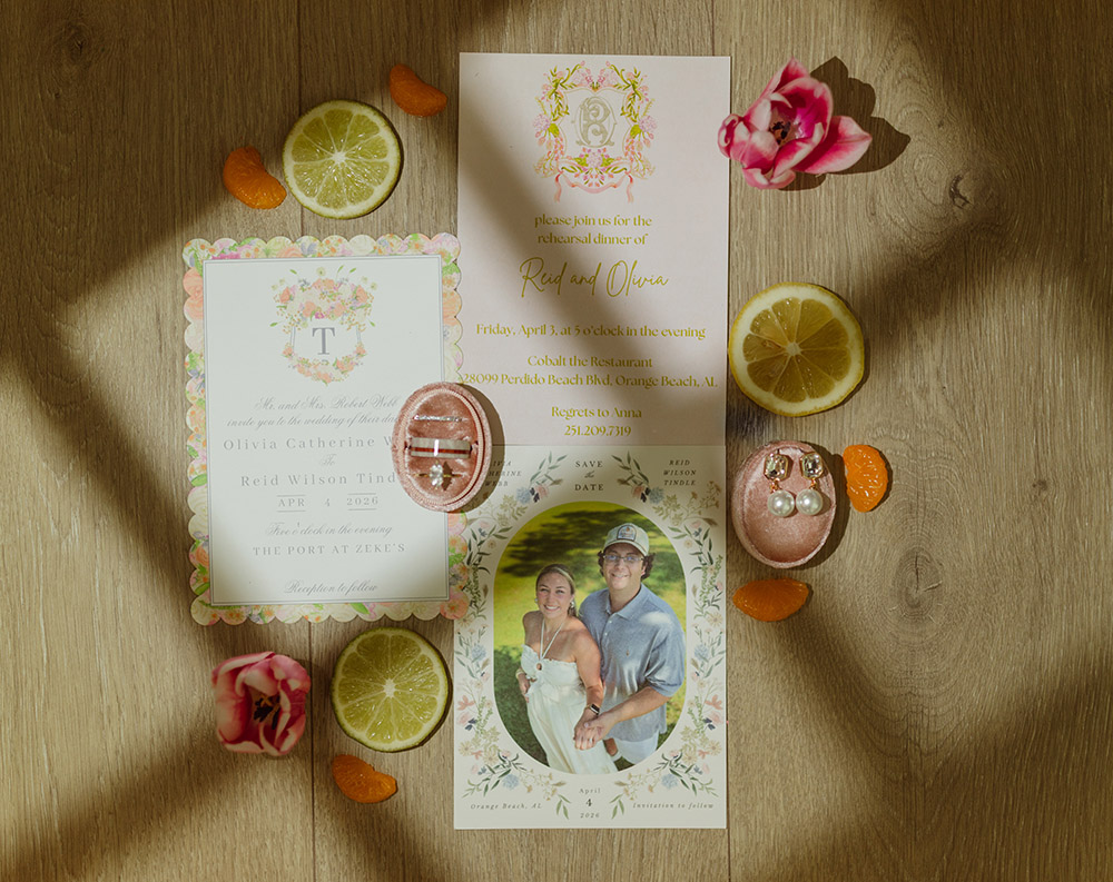 Wedding invitation suite with rehearsal dinner invitation, save-the-date card, ring boxes, and citrus-inspired styling.