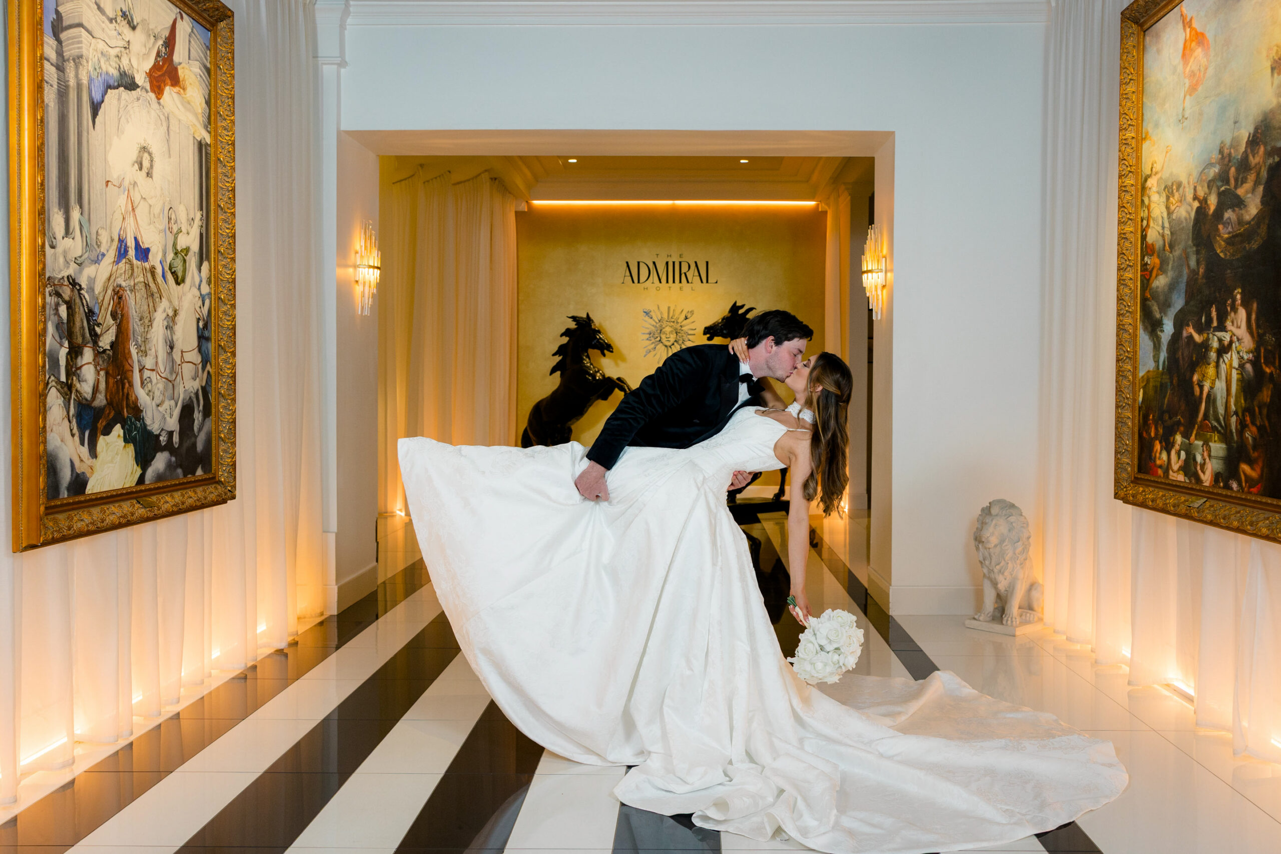 ADM-Weddings-CorridorBrideGroomDramaticKiss-H-Web-CreditJennieTewell