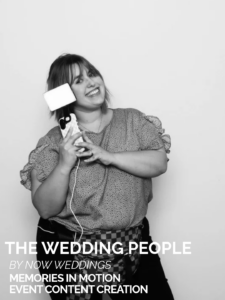 Anna Borne Becnel of Memories in Motion smiling and holding phone on stabilizer, plain background. Text: THE WEDDING PEOPLE BY NOW WEDDINGS MEMORIES IN MOTION EVENT CONTENT CREATION.