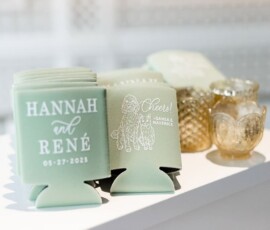 Mint green wedding can coolers with white text and dog illustration beside vintage glass candle holders for elegant inspiration.