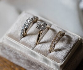 Gold and silver diamond rings with intricate designs displayed on a velvet holder, ideal for Gulf South weddings.