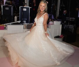 Bride twirls in a white dress on pink-and-white dance floor at night, with band and lights—Gulf South wedding inspiration.