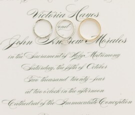 Three wedding rings on a stylish wedding invitation for Victoria Hayes and John Andrew Moraless, October 19th, Mobile, Alabama.