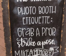 Chalkboard sign: The Shutterbus photo booth etiquette—grab a prop, pose, make memories. Distressed wood frame.